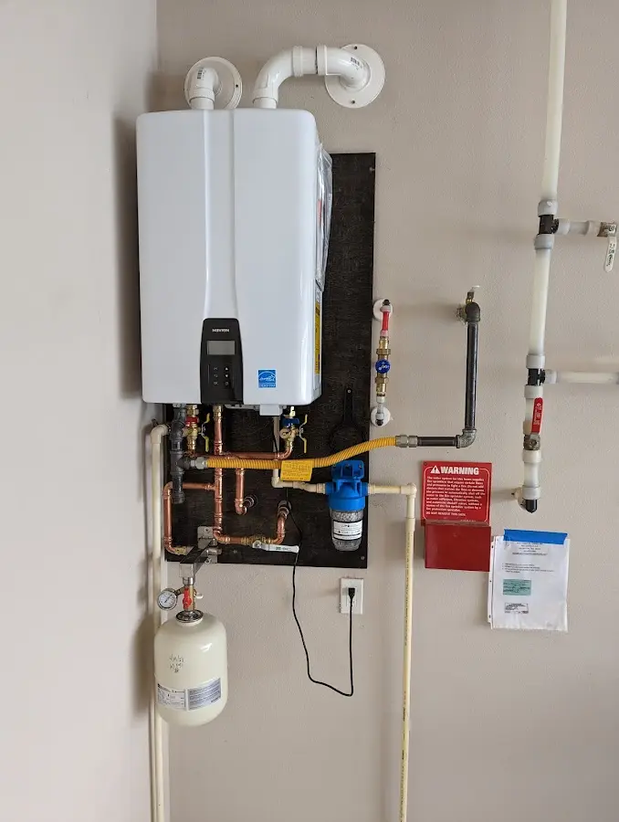 Professional plumber installing copper piping in a Mulberry home